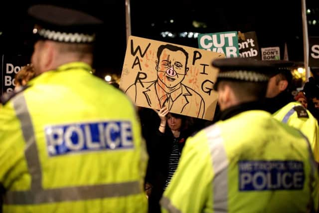 Protesters in Parliament Square in London, during a demonstration against the proposed bombing of the Islamic State in Syria