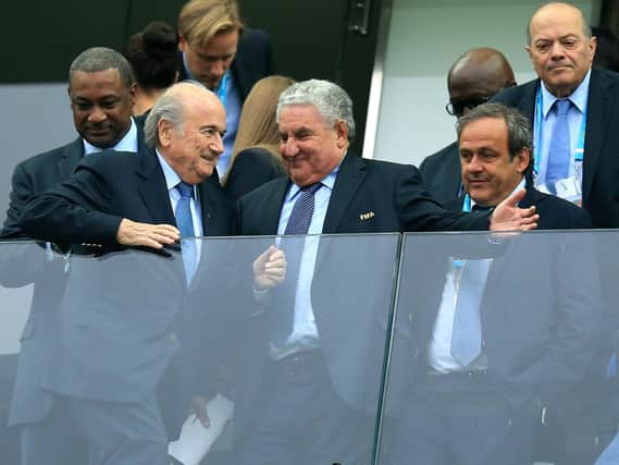 Vice president Michel Platini of FIFA (right) and president Sepp Blatter of FIFA (2nd left) with FIFA vice-president Jeffrey Webb (left) in the stands