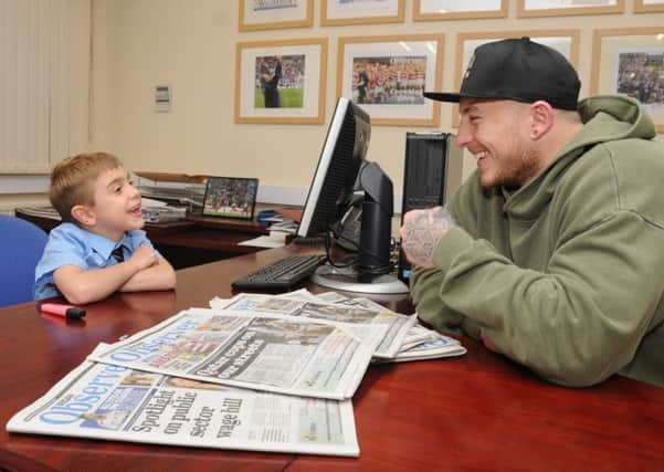 Jack Johnson, the inspiration for Joining Jack charity, makes notes as he interviews Wigan Warrior Josh Charnley, right, pictured at the Wigan Observer office, Martland Mill, Wigan, as he is the guest editor for a special Christmas edition