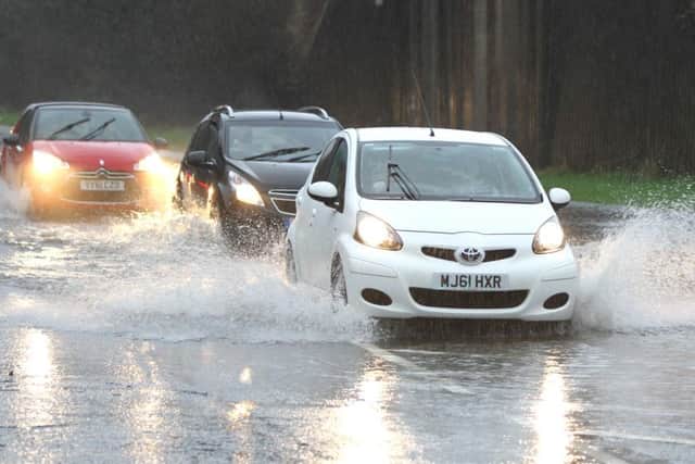 Boxing Day - Martland Mill and Robin Park Road as driver plough through the flooded roads