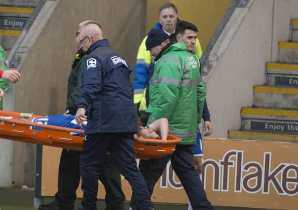Wigan's Michael Jacobs is stretchered off at Crewe