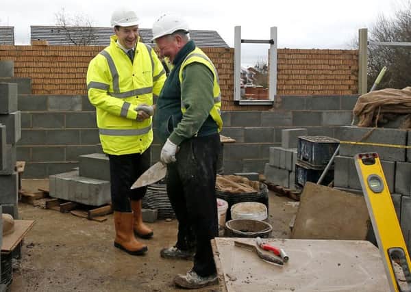 Chancellor George Osborne (left) visits a housing development