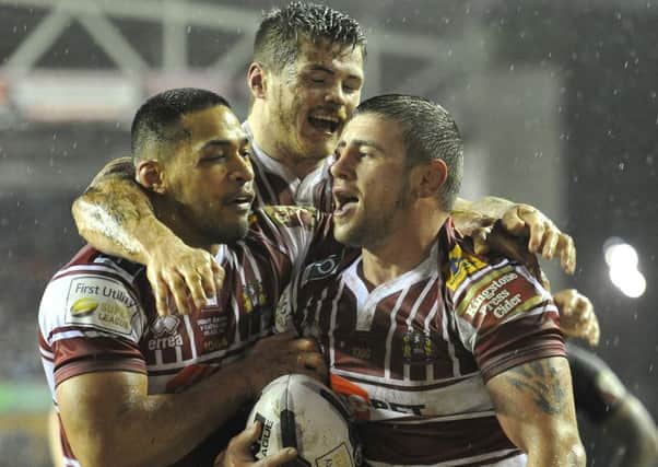 Wigan Warriors' Michael McIlorum is congratulated on scoring his team's first try last Friday