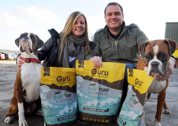 Lisa and Andrew Clarke with dogs Gino and Duke, promote their healthy, cold pressed dog food, Guru