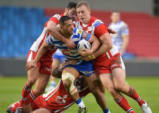 Wigan Warriors' Willie Isa  meets the Salford defence