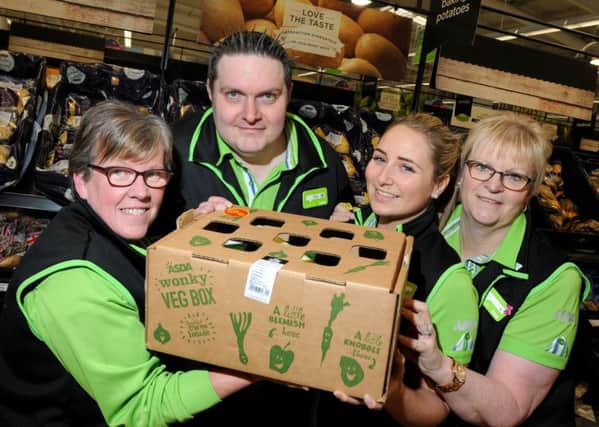 Staff at ASDA supermarket, Wigan, from left, Hazel Bulpitt, Tim Hall, Rachael Harmer and Sheila Bolton, with a box of Wonky Veg which have been flying off the shelves