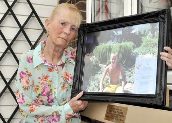 Ann Croston  with a picture of her son, Craig