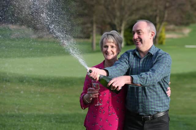 Lucky lottery winners David and Carol Martin celebrate after scooping the jackpot. See letter
