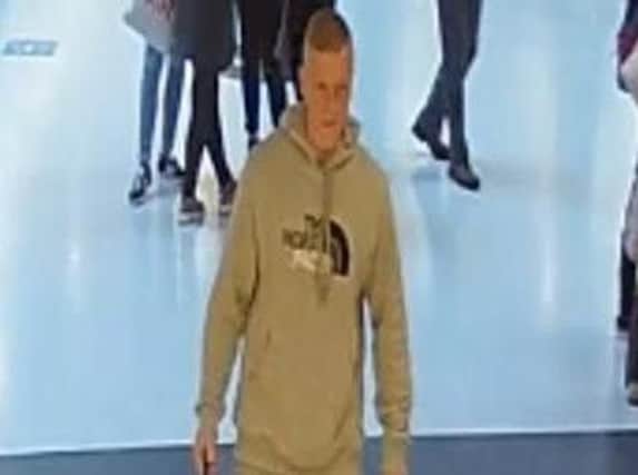 CCTV image of a man GMP want to speak to in connection with the theft of a mobile phone