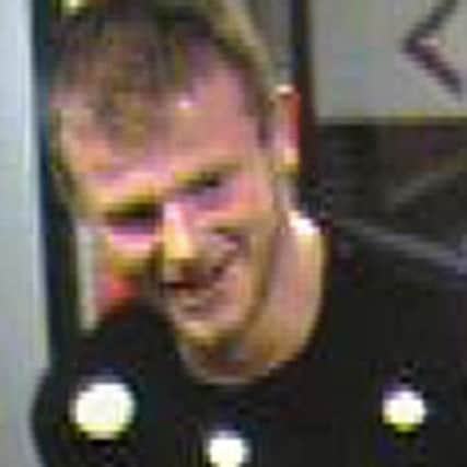 The CCTV image of the man police want to talk to after a suitcase was stolen
