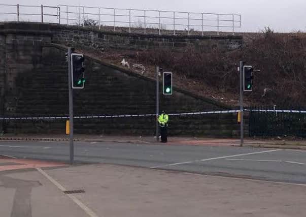 A police officer at the scene where a man was found with a serious head injury on Wallgate near to Saddle Junction