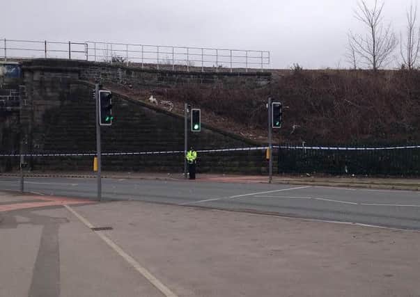 A police officer at the scene where a man was assaulted and suffered a severe head injury