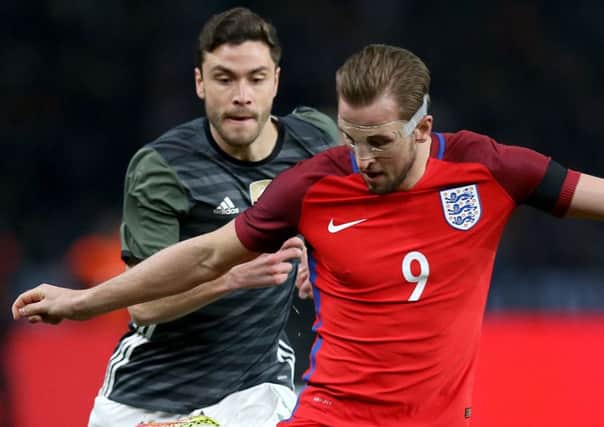 England striker Harry Kane and Germany's Jonas Hector (left)