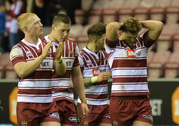 Dejected Wigan players at the final whistle
