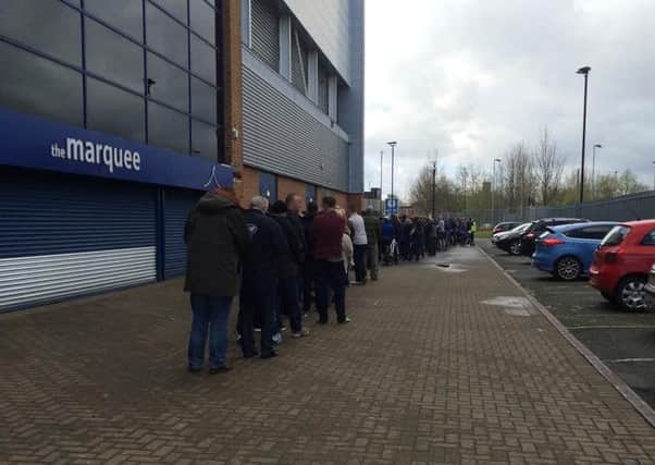 Latics fans queue around the DW Stadium for Blackpool tickets