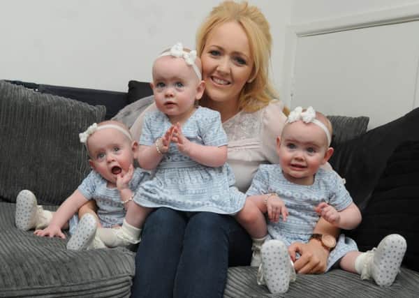 Jaide Ward from Ashton-in-Makerfield, with her 15-month-old triplet baby girls, from left, Scarlett, Caitlin and Francesca