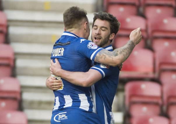 Will Grigg celebrates scoring another goal with Max Power