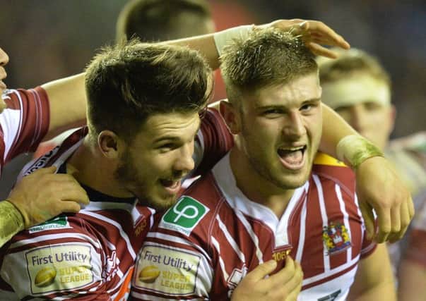 Nick Gregson is congratulated after his first try for Wigan