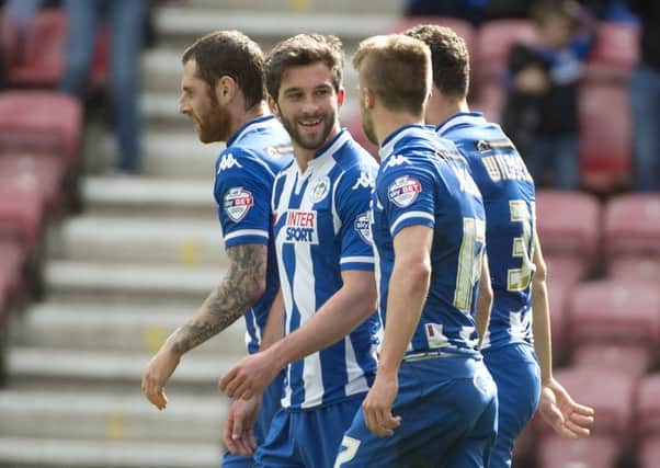 Wigan Athletic players celebrate another goal