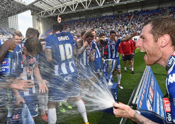 Chris McCann sprays the champagne