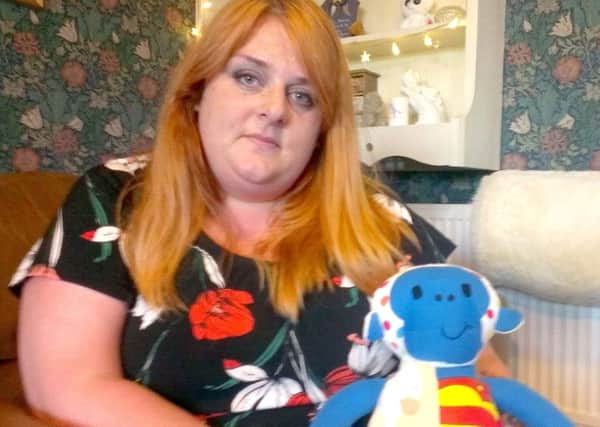 Laura Monks at home in Aspull with a teddy made out of babygrows bought for her stillborn son Rueben