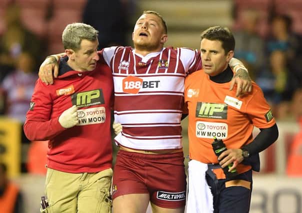 Wigan Warriors' Josh Charnley is helped off the pitch after being injured  against Hull FC