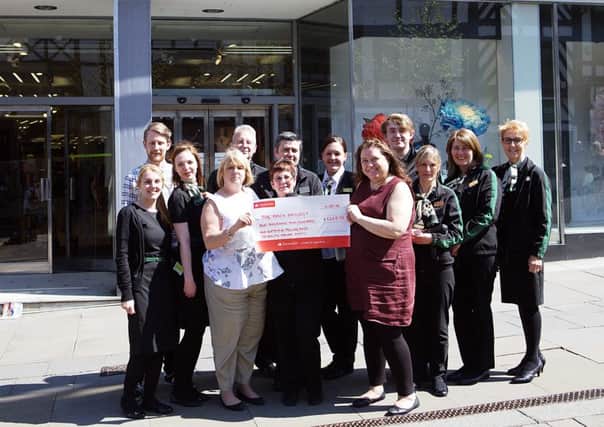M&S Wigan Store Manager Jacqui Lancaster presents the cheque to The Bricks Operations Service Manager Louise Green, with shop staff: Emma deLuce, Chelsea McKay, Barry Fletcher, Sandra Pendlebury, Andy Atherton, Kayleigh Hock, Joe Bish, Natalie Winstanley, Lynn Entwistle, Sue Morrison and The Bricks Food Bank Manager Daniel Pollard