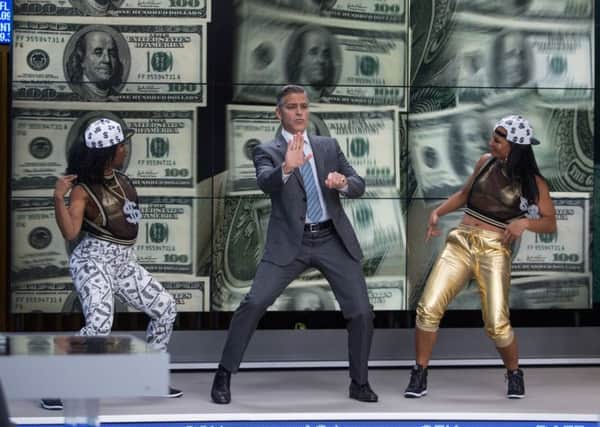 George Clooney (center) stars as Lee Gates