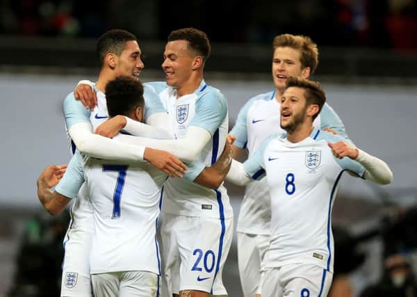England's Chris Smalling (left) celebrates scoring his side's first goal of the game with team-mates Raheem Sterling (7), Dele Alli (20) and Adam Lallana (8) during an International Friendly at Wembley Stadium
