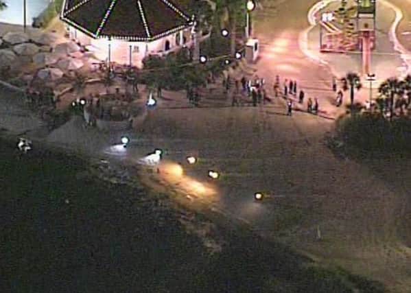 Image taken from video courtesy of WKMG shows an area near where an alligator dragged a 2-year-old boy into the water near Disney's upscale Grand Floridian Resort & Spa in Orlando (Courtesy WKMG via AP)
