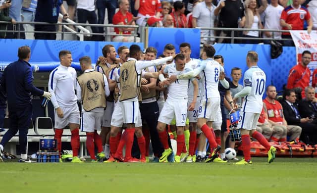 England's Jamie Vardy celebrates with his team mates after scoring his side's first goal Wales