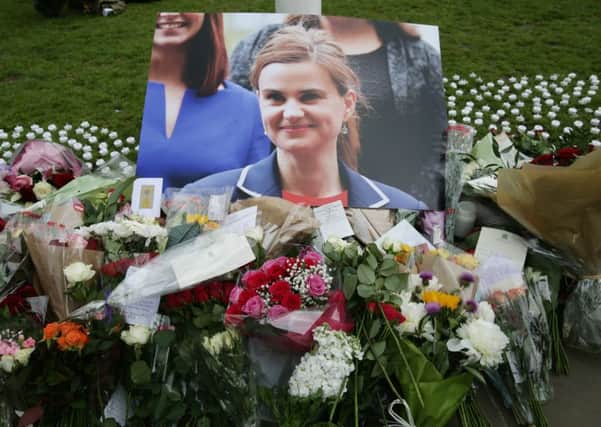 Floral tributes left in Parliament Square, London, after Labour MP Jo Cox was shot and stabbed to death. See letter