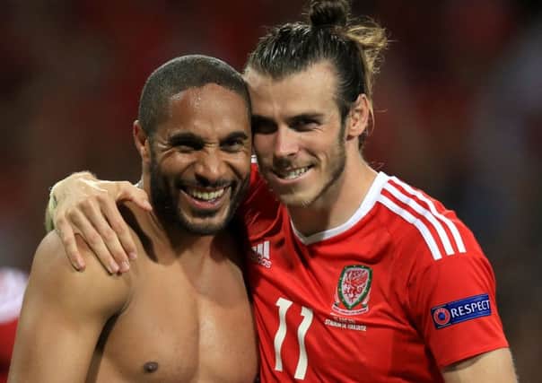 Ashley Williams (left) and Gareth Bale celebrate victory over Russia