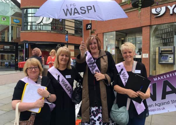 MP Yvonne Fovargue wields the umbrella at the Wigan town centre Waspi protest