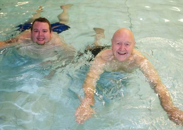 Ron Fuller, who lives at Belong Atherton, in the swimming pool with support worker Mike Brimelow