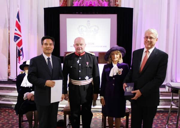 General Pastor Kim Joo-Choel and senior church leader Michael King receiving the Queen's Award from the Lord Lieutenant of Greater Manchester