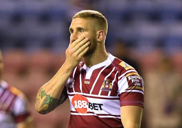Sam Tomkins left the DW Stadium wearing a protective boot