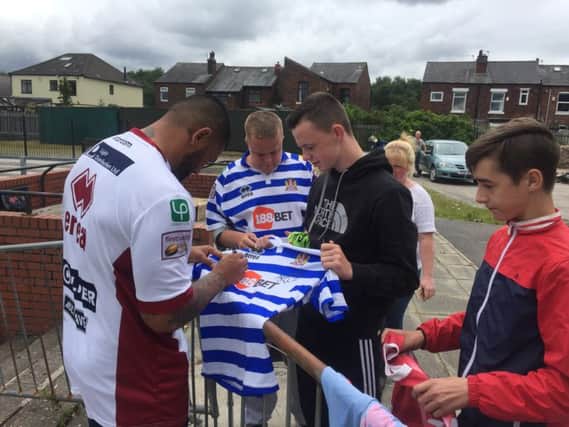 Frank-Paul Nuuausala signs autographs at Wigan's training ground