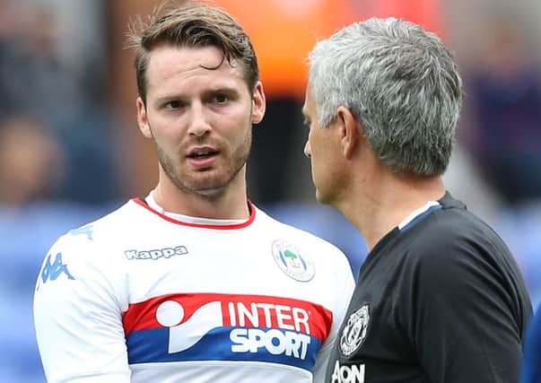 Wigan Athletic's Nick Powell (left) shakes hands with Manchester United manager Jose Mourinho at the DW Stadium.
