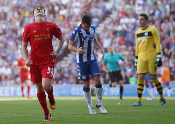 Ben Woodburn scores the second Liverpool goal against Wigan Athletic