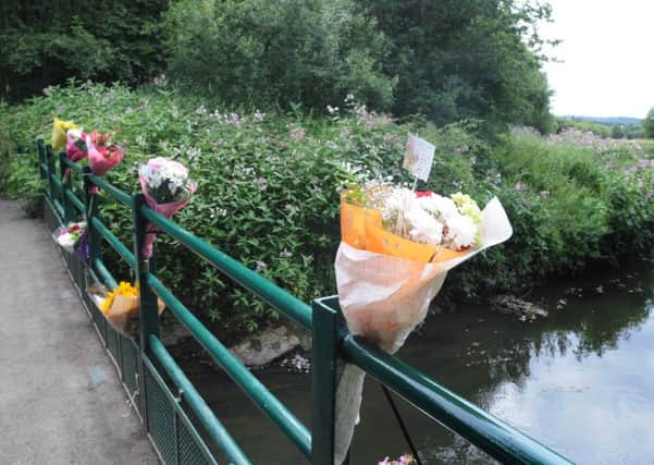 Flowers and tributes at the scene where the body of a 25-year-old man was found