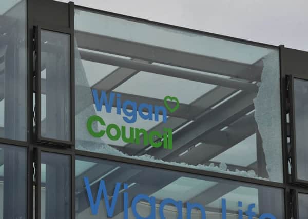 Exterior of Wigan Life Centre, showing the broken glass panel
