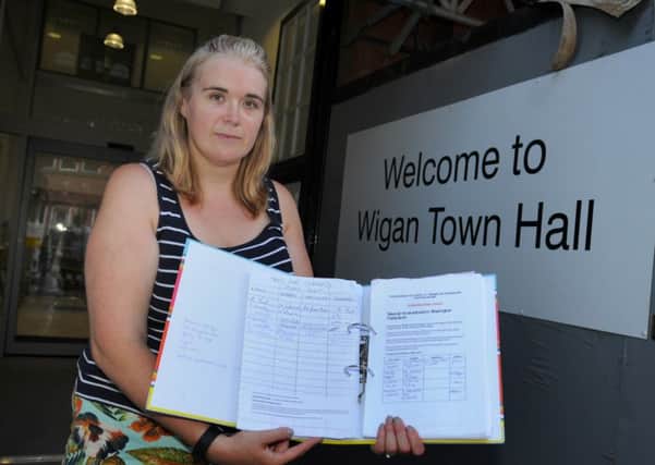 Vicky Galligan, members of Save Shevington Federation and founder of the petition against the proposed closure of a Shevington Primary School, gets ready to hand over the petition with over 1,900 signatures, to Wigan Town Hall.
