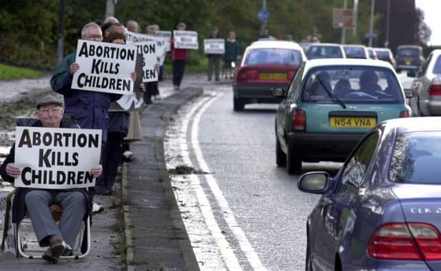 Anti-abortion campaigners take part in a protest, see letter below