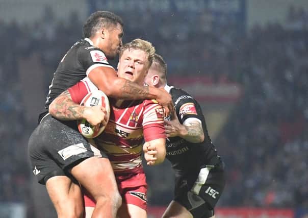 Ryan Sutton, seen copping a high shot against Hull, is among Shaun Wane's crop of rising stars