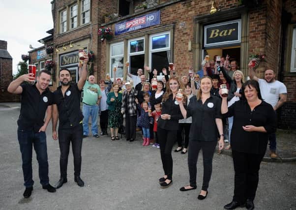 Regulars and Beech Hill residents rallied round when their local Sam's Bar was threatened with closure, and following a successful campaign the pub has been saved and will soon be re-launched as the Wellfield Hotel.
Landlord Chris Tolley (left) and Co-Manager Jean Cubas celebrate with staff and regulars.  PIC BY ROB LOCK
3-8-2016