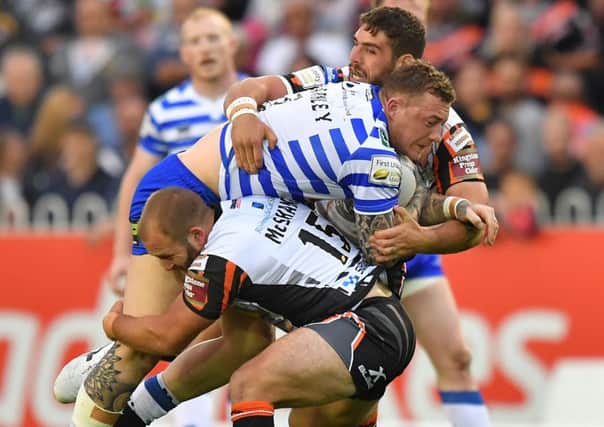 Wigan Warriors' Josh Charnley is tackled by Castleford Tigers' Paul McShane