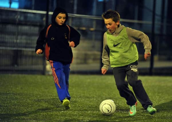 Youngsters playing football at Wigan Youth Zone