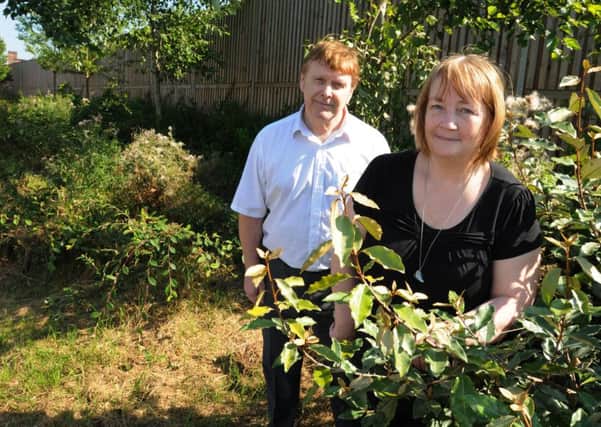 Councillor Mike Dewhurst and Coun Shirley Dewhurst are trying to sort out the overgrown planted areas at the end of Eleanor Street, Wigan, as residents have complained about it looking a mess