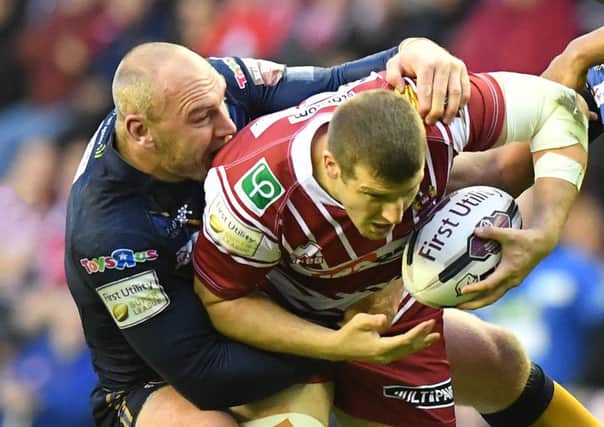 Tony Clubb is tackled by Gareth Ellis in May, his last match this season